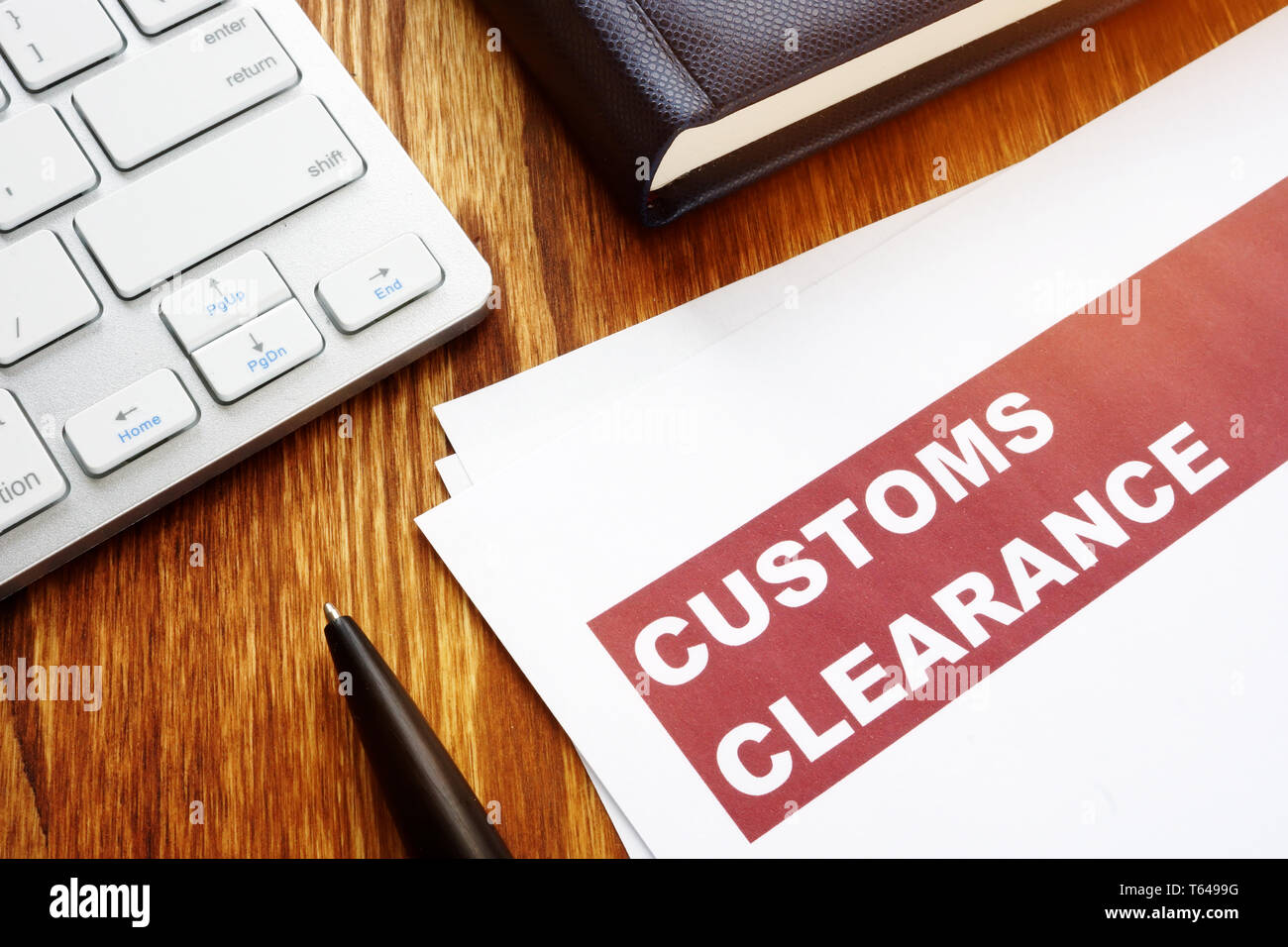 customs clearance documents on an office table T6499G